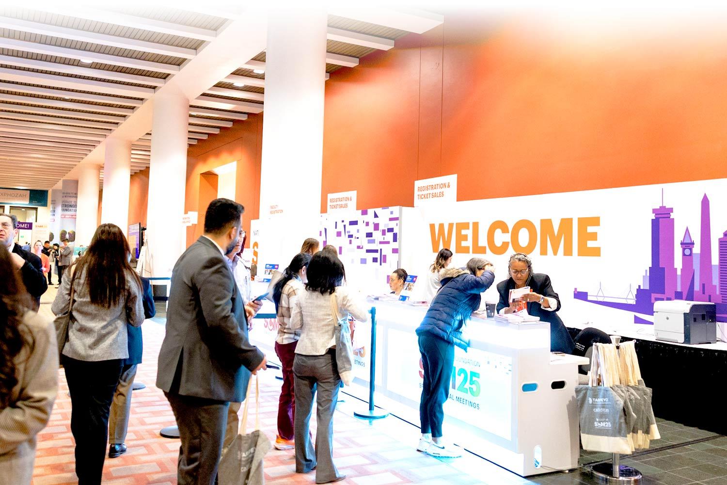 Registration area at SCM25 with a Welcome sign