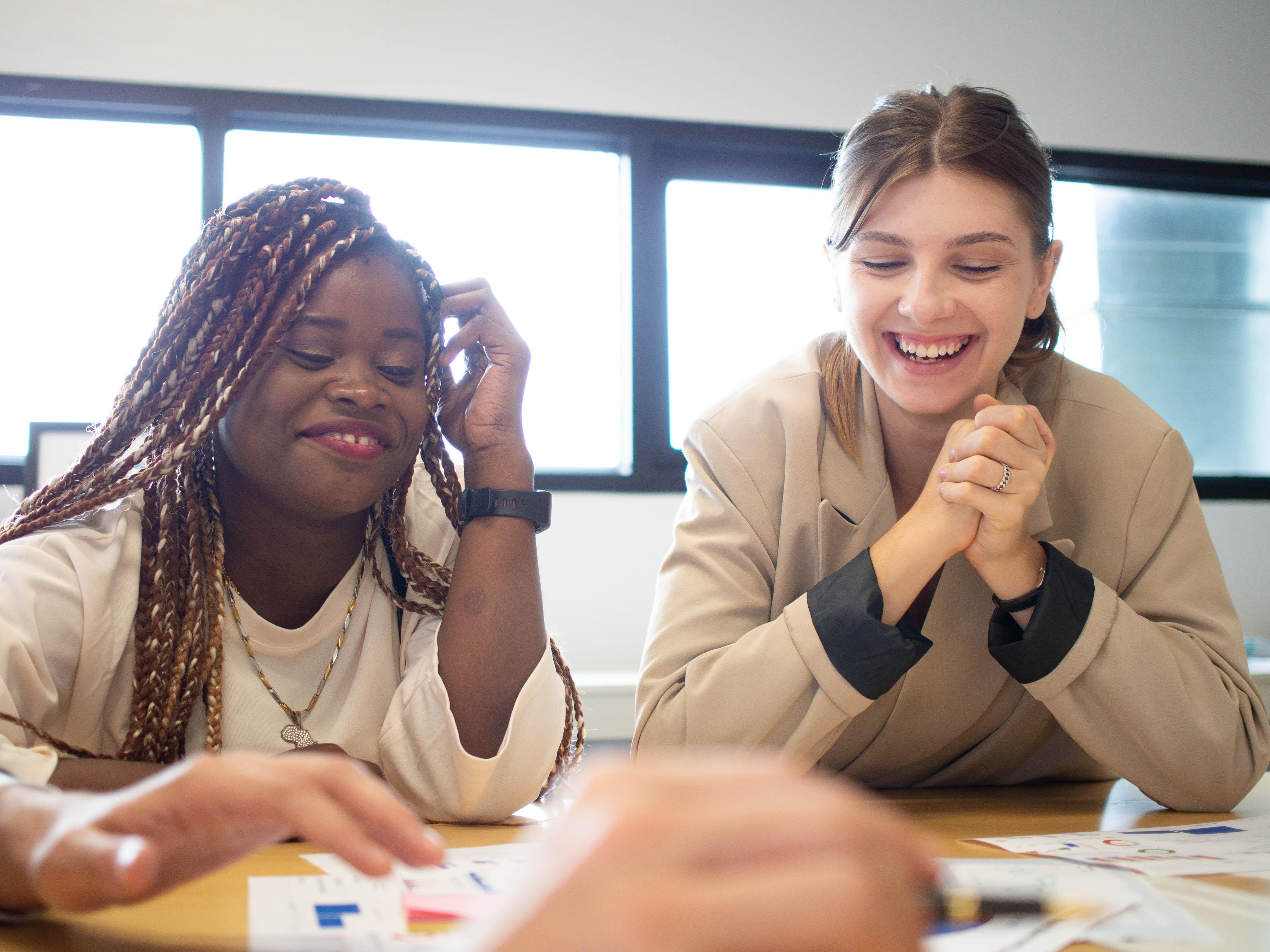 Two employees brainstorming and working together happily
