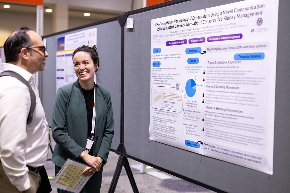 two professionals looking at an abstract poster