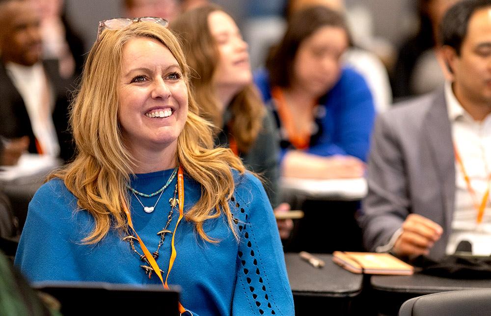 Female professional smiling while in a conference setting