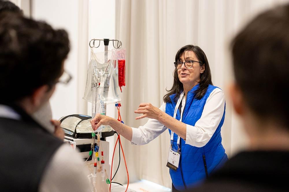 Female professional presenting next to medical equipment