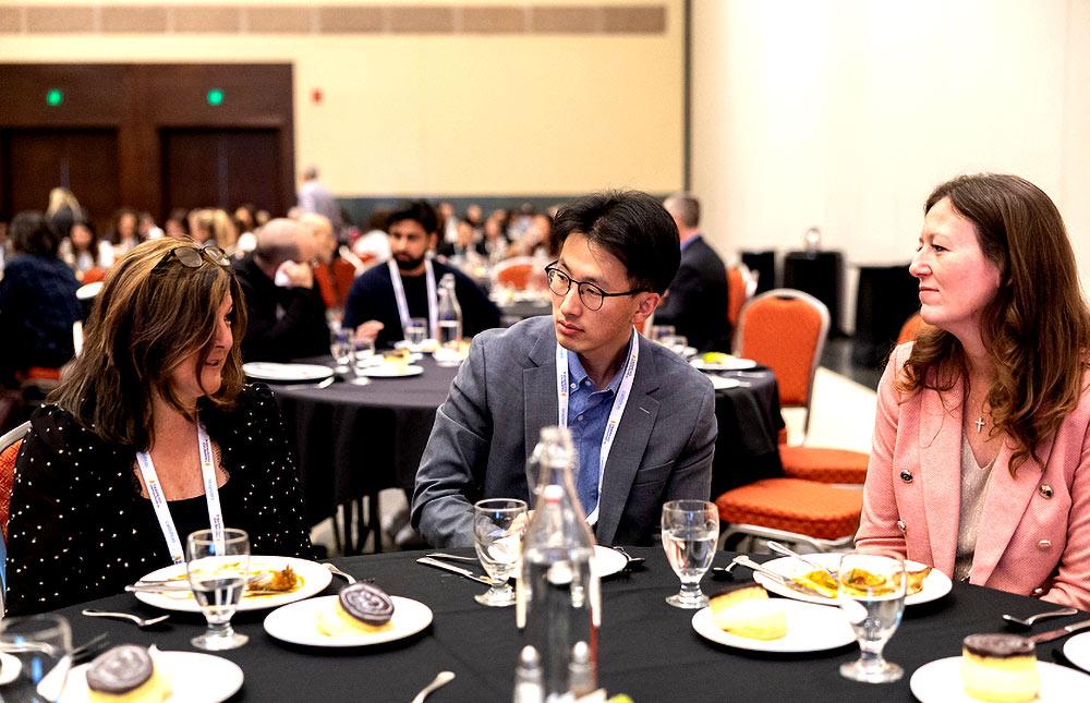 Professionals sitting at a lunch table in discussion