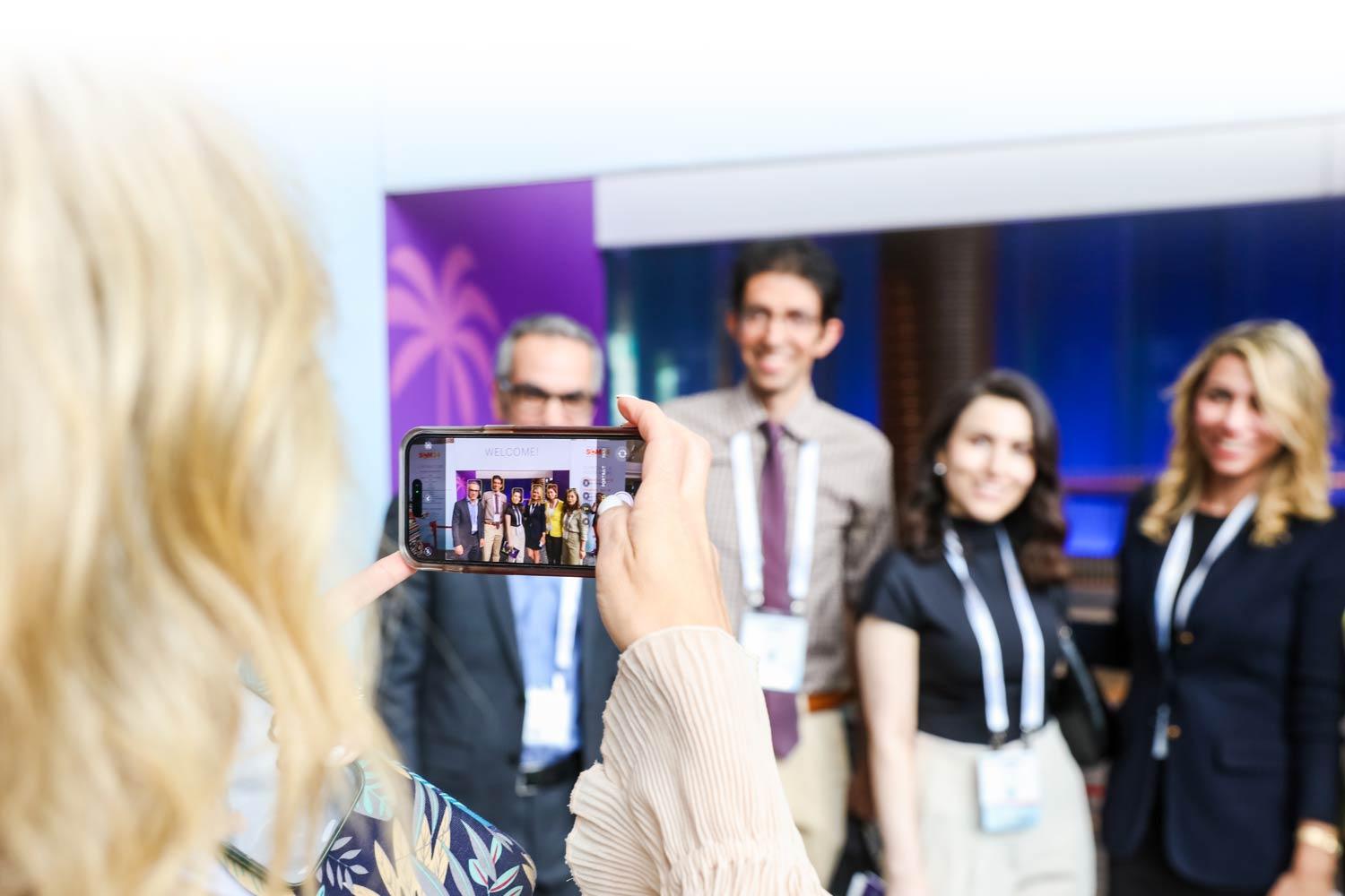 Person taking a photo of a group of SCM attendees