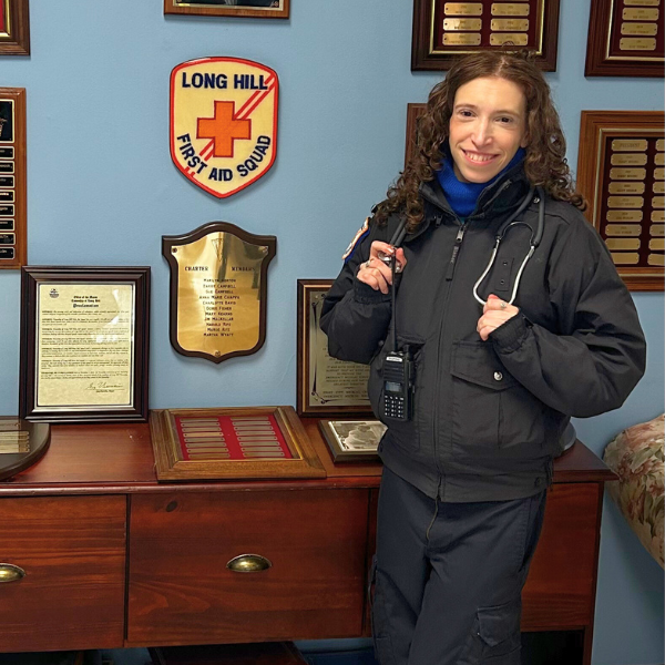 Andrea posing in front of Long Hill First Aid Squad sign