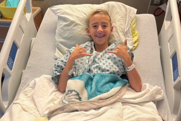 Rory giving cool hand gesture in hospital bed