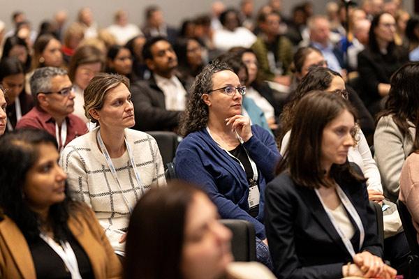 A group of professionals attending a lecture at SCM