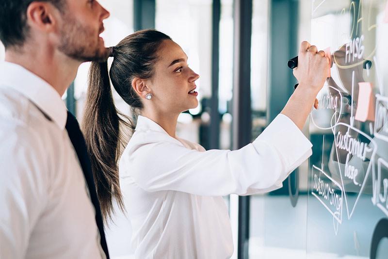 Two professionals brainstorming in their office