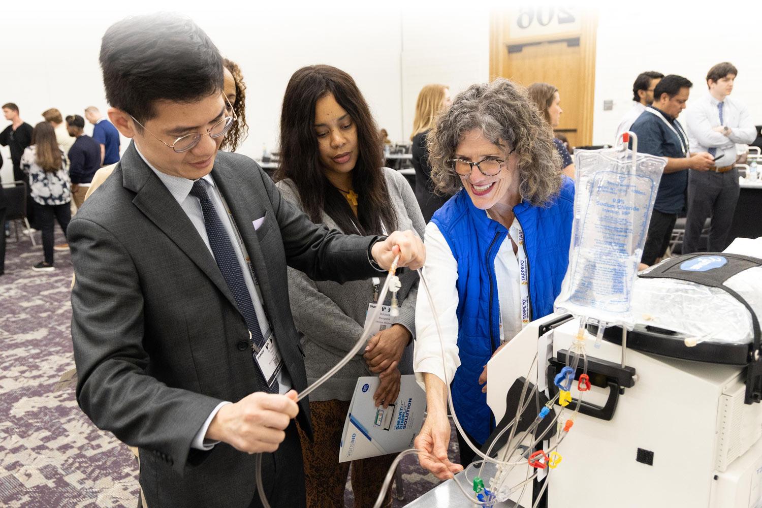 Small group of attendees in a hands-on learning session with medical equipment