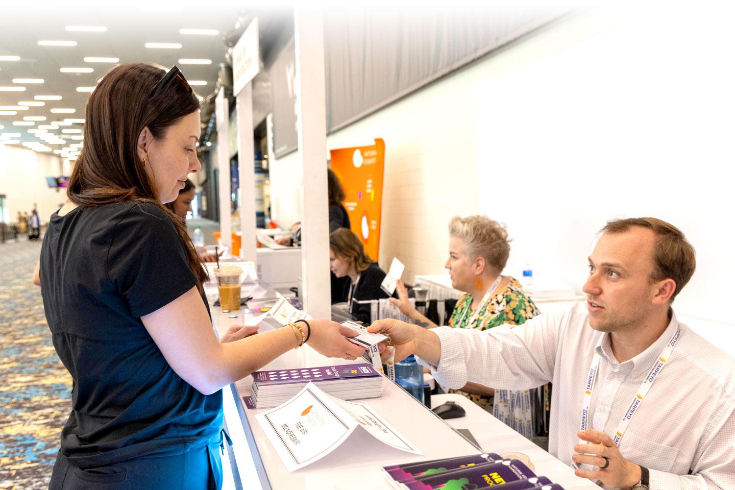 An attendee at the registration desk at SCM