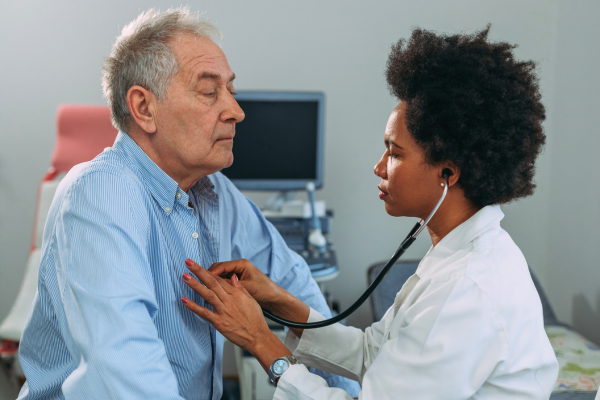 Doctor listening to patient's heart