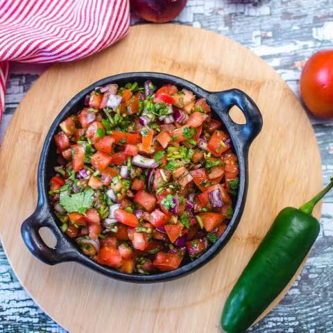 Fresh tomato salsa in a terra cotta bowl
