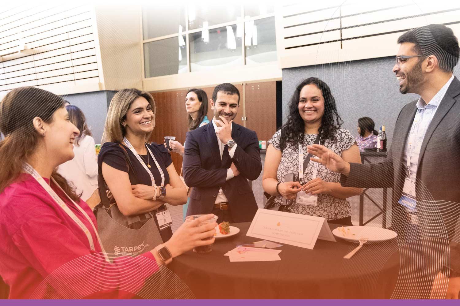 Group of SCM attendees chatting around a table