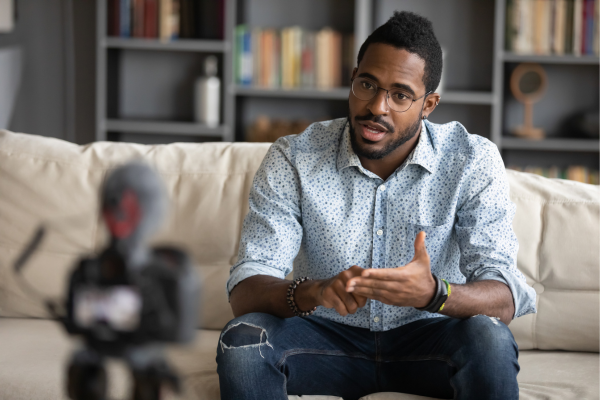 Person filming a webinar on the couch