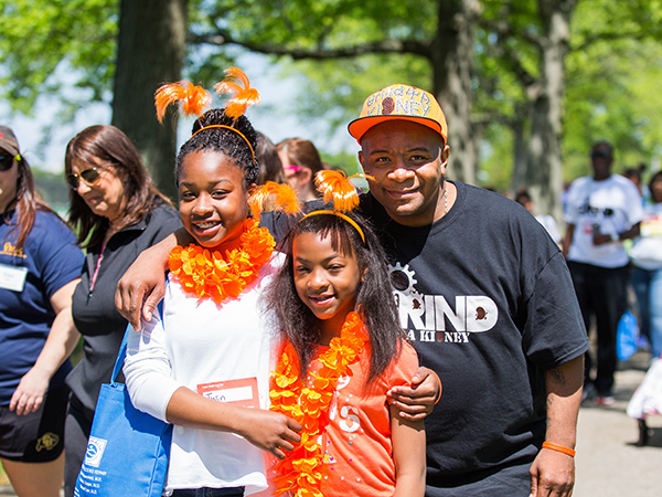a family posing at an NKF walk event