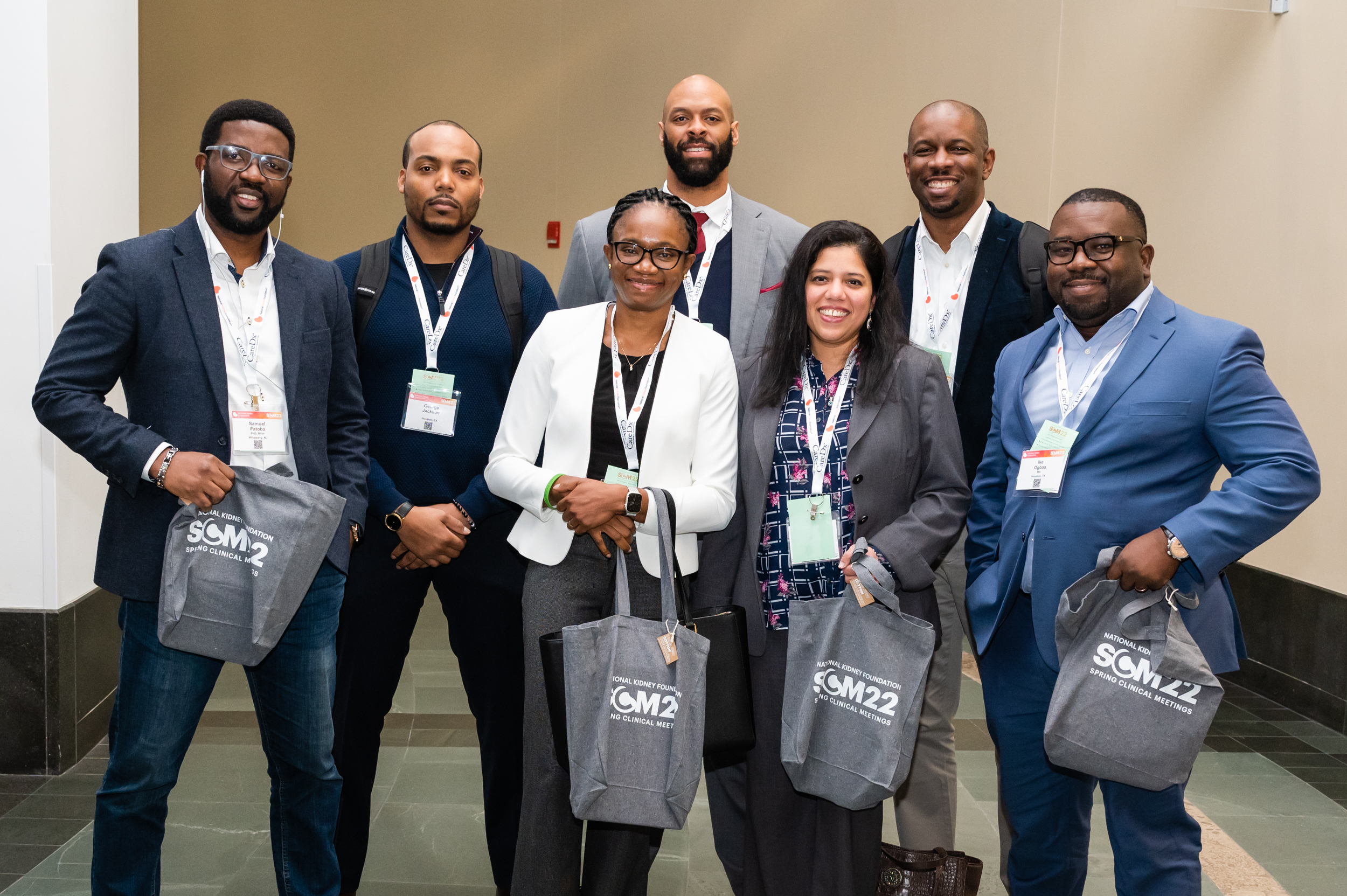 man and woman posing with NKF swag bags at a past spring clinical event