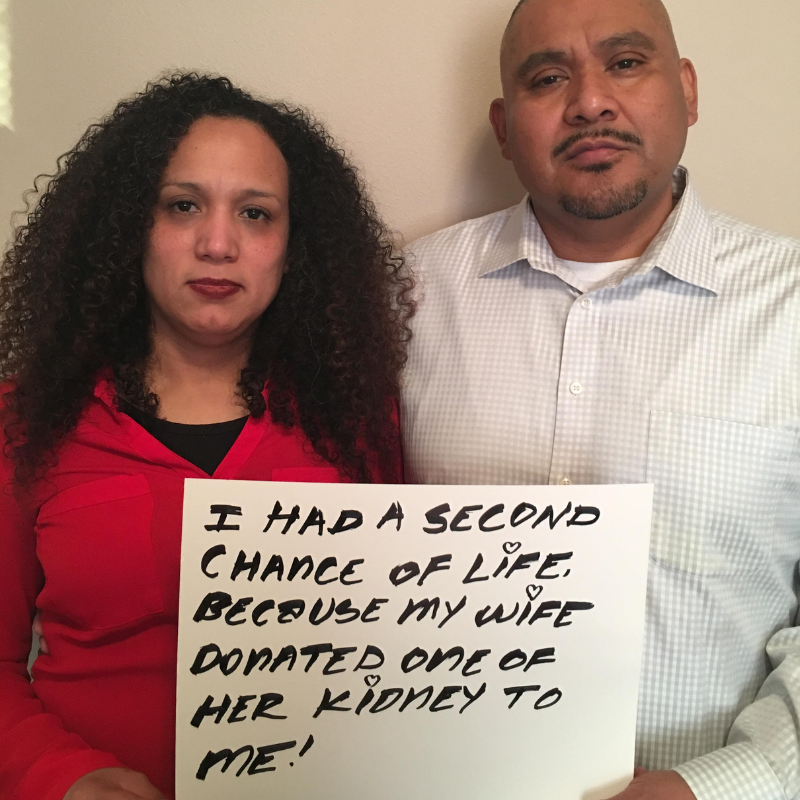 Couple holding sign "I had a second chance of life because my wife donated a kidney to me."