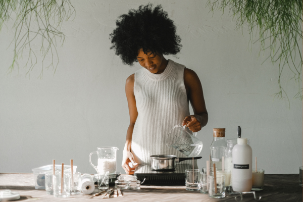 Person happily making candles