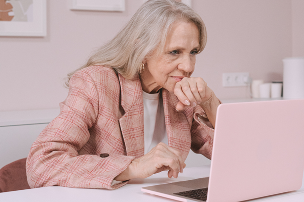 Older person looking intently at computer